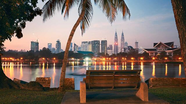 View from a park bench in Kuala Lumpur city, looking across a lake to city high rise buildings