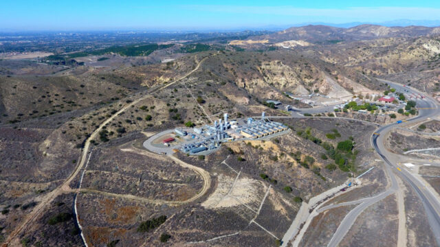 Aerial view of a landfill gas beneficial-use project located among rolling hills